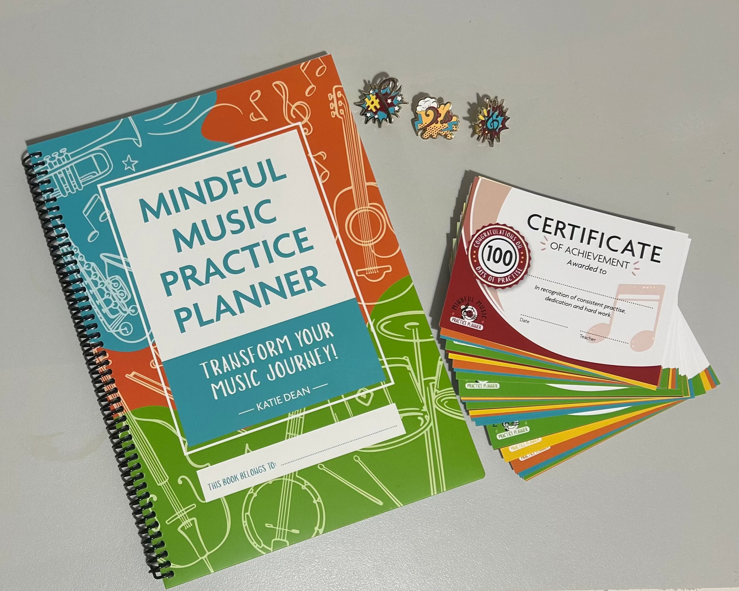 Mindful Music Practice Planner with colourful design and a certificate of achievement and reward pins for piano, guitar, violin or drum lessons.